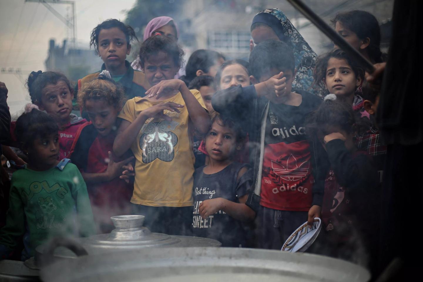 Children waiting for a community meal in Gaza